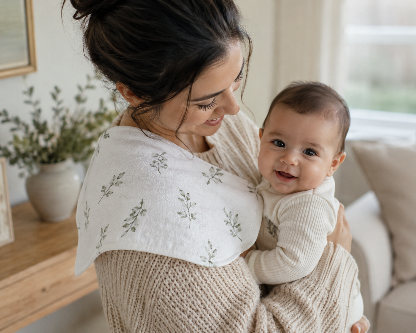 Mother and smiling baby using a neutral botanical cotton burp cloth